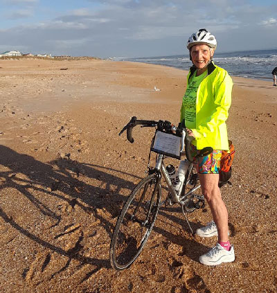 Carol Garsee with her bike on the Florida coast.