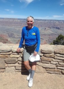 Carol standing at a lookout point on a Grand Canyon trail.